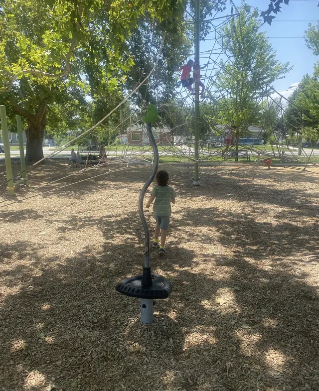 The shaded play yard with climbing structures